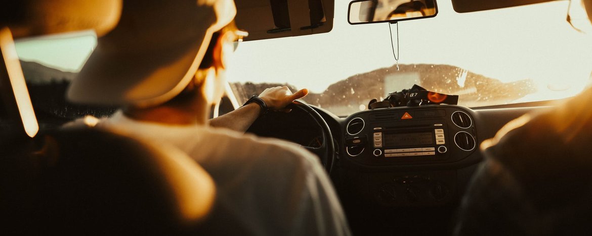 Man driving a car in the summer